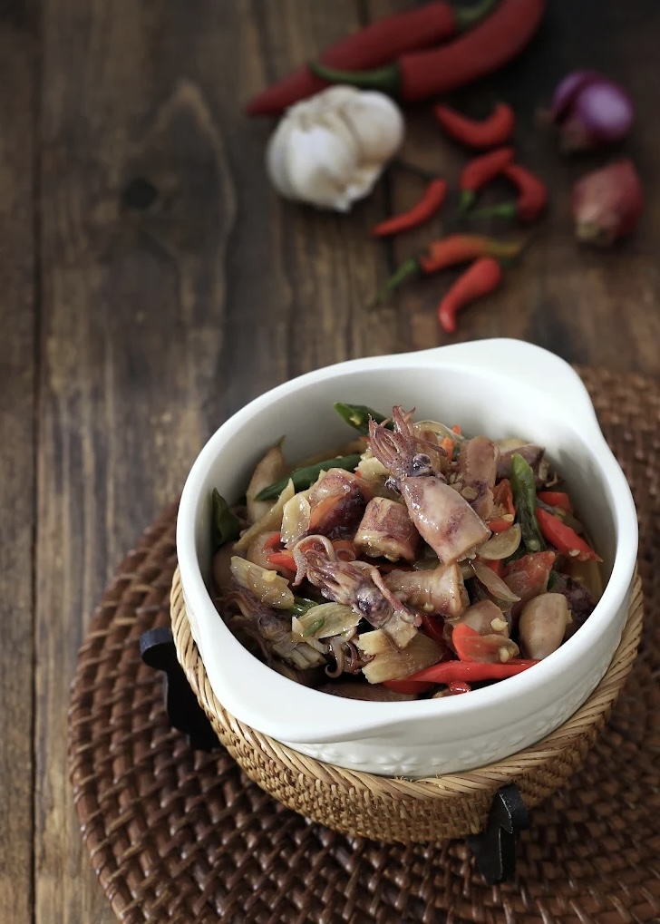 Tumis Cumi Asin pedas or sauteed salted squid spicy on a bowl, Indonesian traditional cuisine, selective focus.